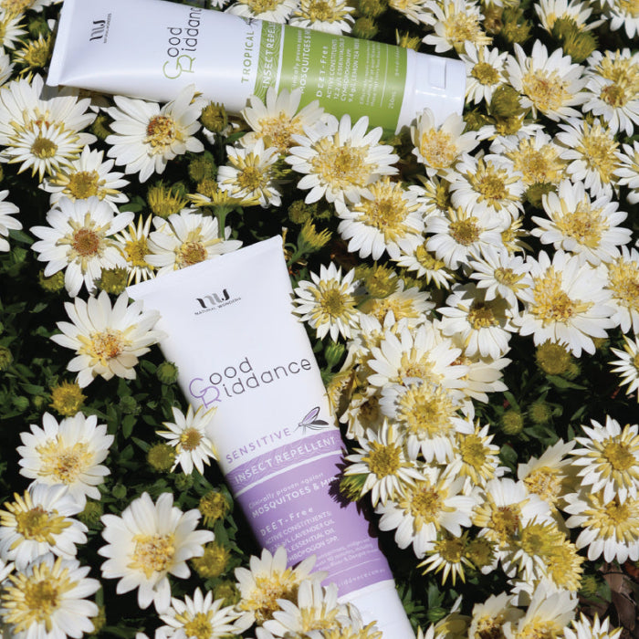 Good Riddance sensitive insect repellent tubes among white flowers, natural DEET free mozzie protection for travel Adventure Awaits