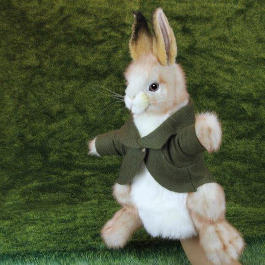 Stuffed rabbit toy wearing a green sweater with Hansa logo on a green background