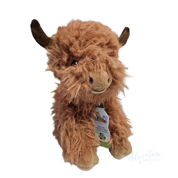 Plush toy highland cow with a visible tag on a white background