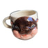 Ceramic mug with a hippopotamus design on a white surface