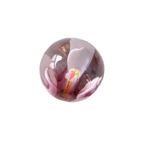 Pink glass marble with white flower-like swirls and small multicoloured centre — Adventure Awaits