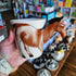 Mug with horse design held in a store setting