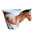 Decorative horse-shaped item on a wooden surface with a blurred background
