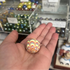 Colourful glass marble with red, yellow and blue swirls resting in an open hand — Adventure Awaits