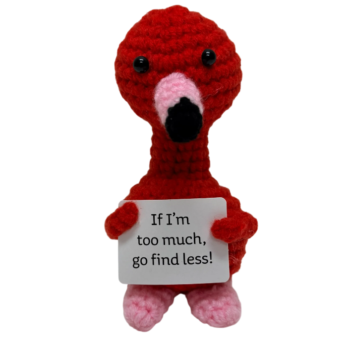 handmade crochet flamingo plush toy holding a bold “If I’m too much, go find less” quote sign