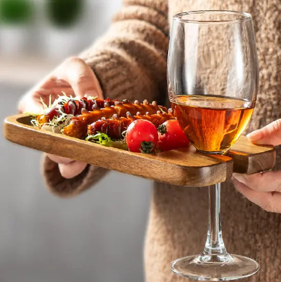 Wooden serving tray holding snacks and wine glass at home — Adventure Awaits