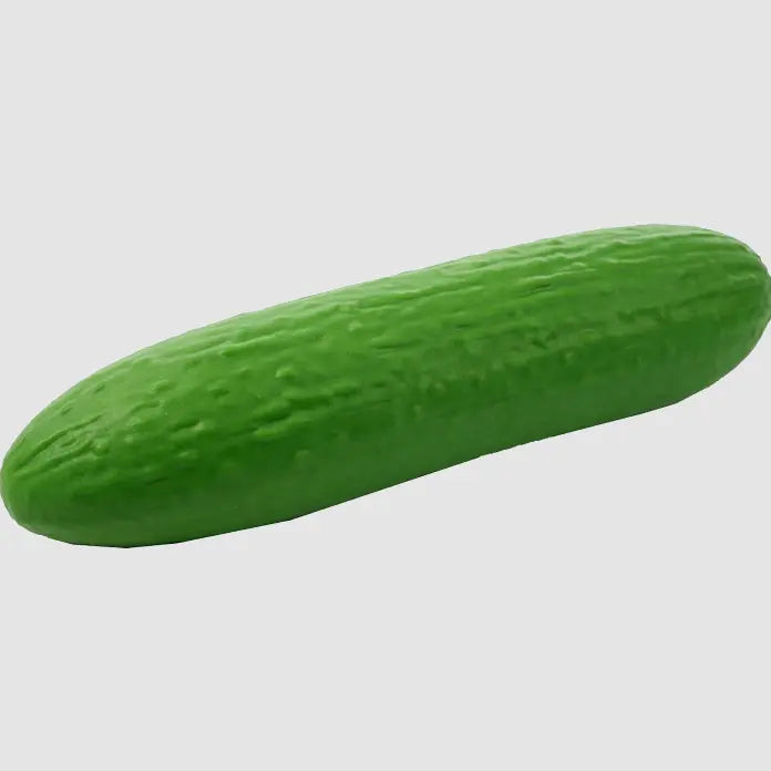 Green cucumber-shaped novelty toy with textured skin on a plain background — Adventure Awaits