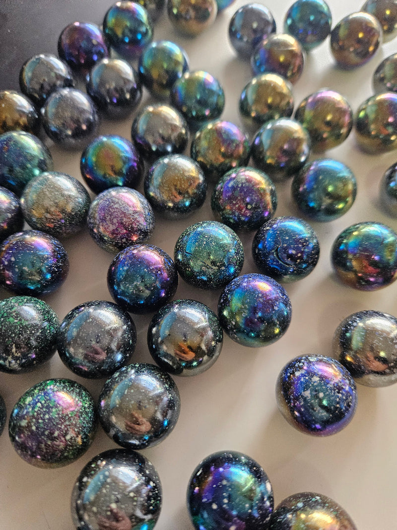 Iridescent marbles on a white surface