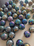 Iridescent marbles on a white surface
