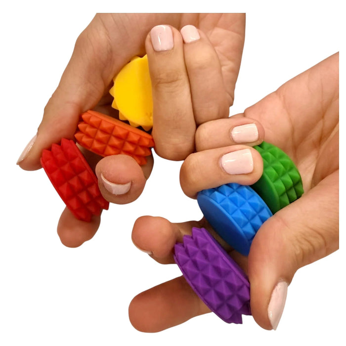 Hands using Kaiko MagStak Core magnetic stacking toy with colourful textured discs, ideal for sensory play, focus and fidgeting at home or travel Adventure Awaits