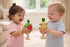 Toddlers playing with wooden fruit music set twist drum and bell stick — Adventure Awaits