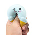 hand squeezing soft blue ice cream squishy toy with cute face, stretchy sensory toy for kids play and stress relief Adventure Awaits