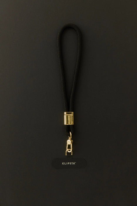 Black Klipsta phone wrist strap with gold clasp and phone connector tab, Adventure Awaits
