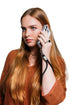 Woman takes a call with her phone secured by a black wrist strap, Adventure Awaits