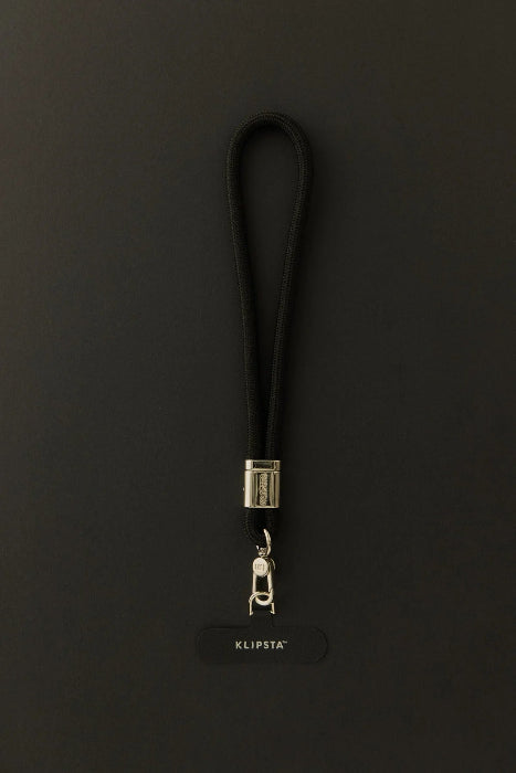 Black Klipsta phone wrist strap with gold clasp and phone connector tab, Adventure Awaits