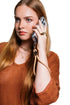 Woman takes a call with her phone secured by a tan wrist strap with gold clasp, Adventure Awaits