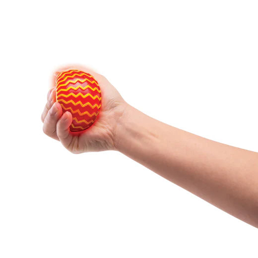 Hand squeezing red and yellow Light Up Space Ball — Adventure Awaits