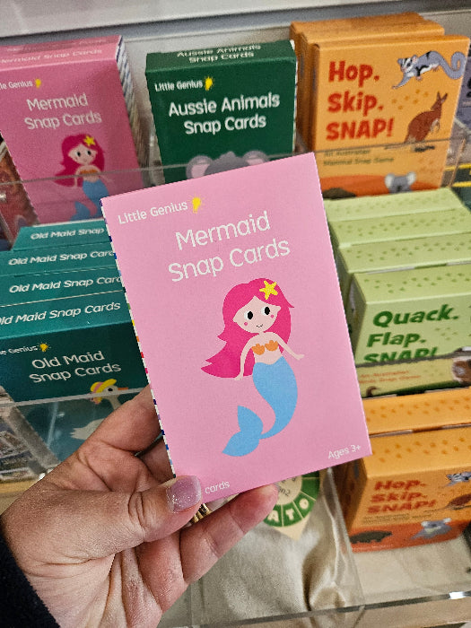 Adventure Awaits Little Genius Mermaid snap cards box held in store with colourful kids game displays behind