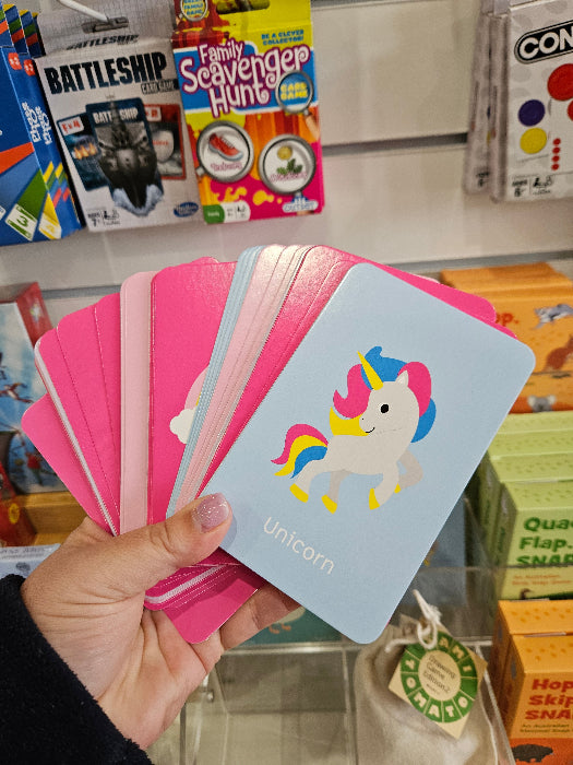 Adventure Awaits Little Genius Unicorn snap cards fanned out in hand with colourful unicorn illustration