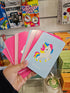Adventure Awaits Little Genius Unicorn snap cards fanned out in hand with colourful unicorn illustration