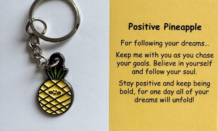 Positive Pineapple keyring with yellow comfort charm and support card close-up — Adventure Awaits
