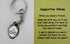 Supportive Sheep keyring with white comfort charm and support card close-up — Adventure Awaits