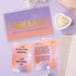 Self-Love card game with affirmation, uniqueness and journalling cards beside heart candle — Adventure Awaits