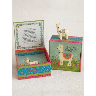 llama lucky charm shown in box and on top of box