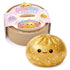 A Lucky Bao Squeeze & Collect toy set shown with its round beige plastic container and a large golden glitter dumpling squishy in front. The container has a colorful pink label reading 'Lucky Bao' and shows assorted collectible bao designs.