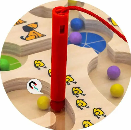 Red magnetic pen guiding colourful balls through a wooden counting maze — Adventure Awaits