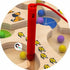 Red magnetic pen guiding colourful balls through a wooden counting maze — Adventure Awaits