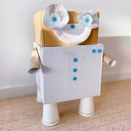 Cardboard robot made with Makedo connectors, paper plate eyes and cup legs during creative play — Adventure Awaits