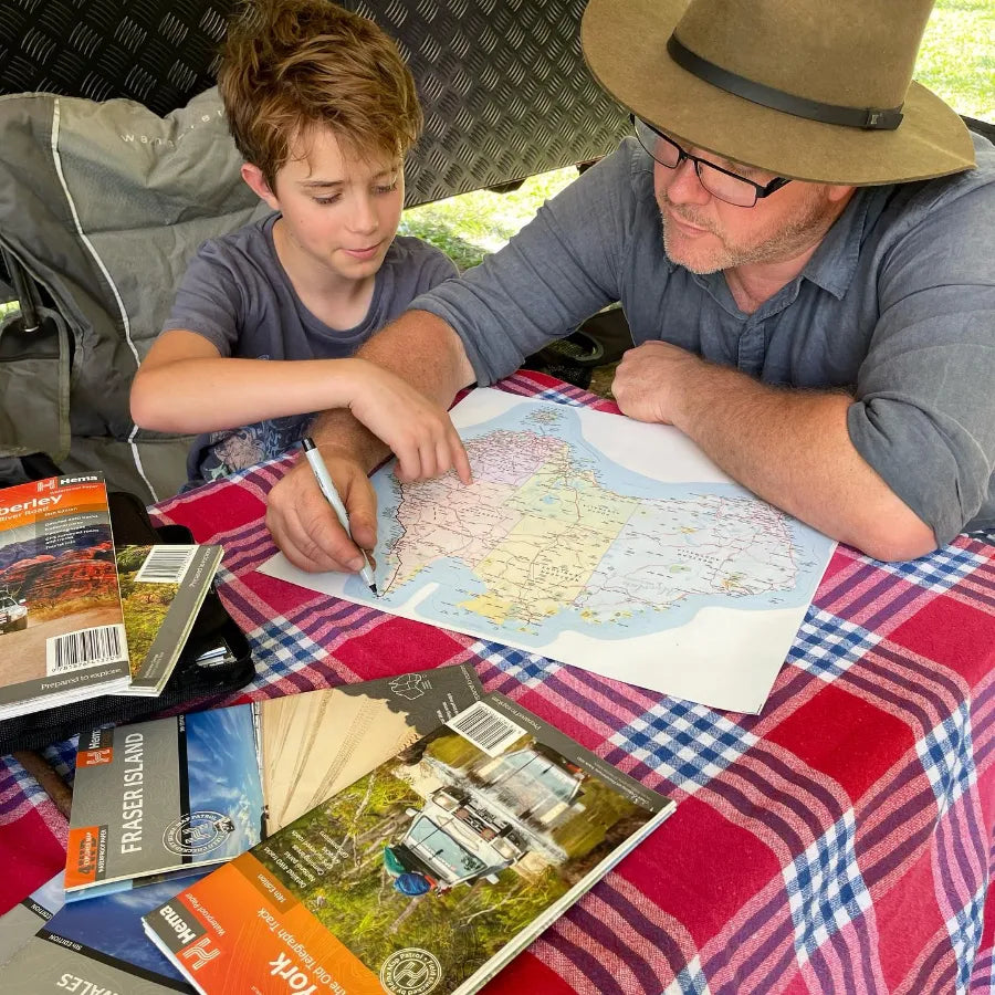 Family using a Map of Australia Sticker inside a caravan on a road trip — Australian made travel tracker for caravanners
