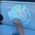 Australian Made Map of Australia Sticker being applied to a caravan exterior surface  - UV Outdoor vinyl decal