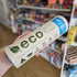 Hand holding an eco-friendly product package in a store setting