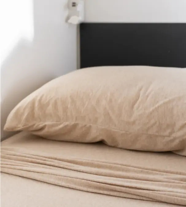 Beige caravan bunk bed pillow and bedding in a minimalist modern camper sleeping space