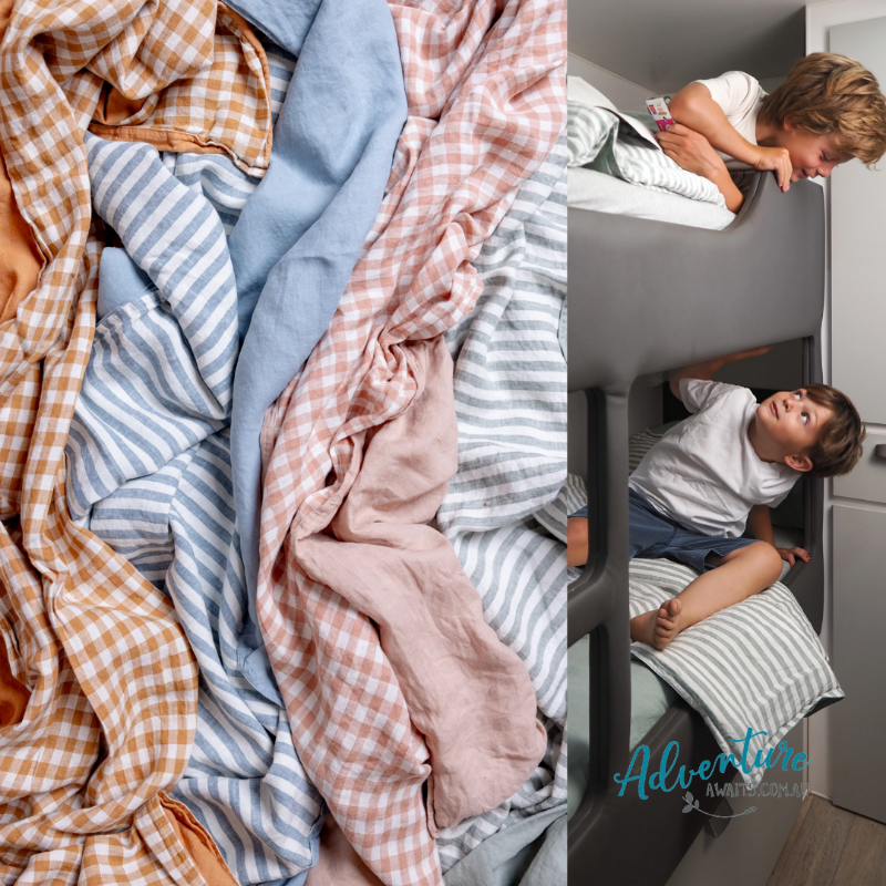 Stack of colorful checkered and striped fabrics with two children playing on a bunk bed.