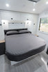 MeanderWild charcoal flannelette sheet set on a queen caravan bed — soft and warm for Aussie winters on the road — Adventure Awaits