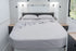 MeanderWild driftwood flannelette sheet set on a queen caravan bed with overhead window and reading lights — Adventure Awaits