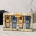 Men's grooming set in a wooden-style box from Men's Republic, containing four mini skincare tubes: shave gel, moisturiser, post-shave balm, and face wash & scrub, displayed on a marble surface.