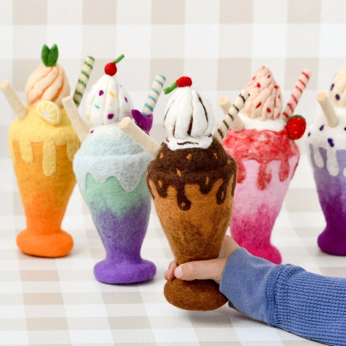 Colorful felt ice cream cone toys on a checkered tablecloth
