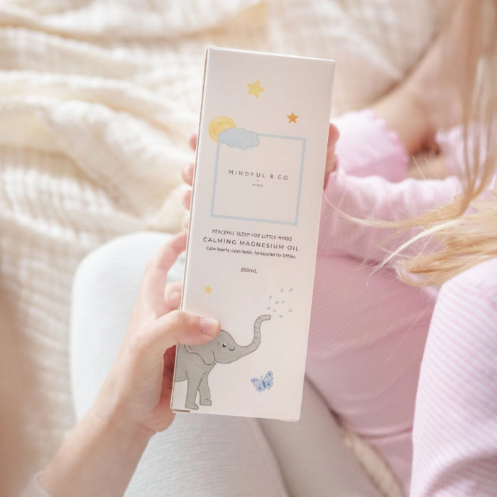 Adult holding Mindful and Co calming magnesium oil box with child nearby, gentle sleep support for babies and children at home or travel Adventure Awaits