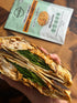 Mingle Marry Me Chicken recipe base beside toasted chicken and spinach wrap cut in half — Adventure Awaits