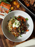Mingle Moroccan BBQ seasoning beside a bowl of spiced beef, couscous, apricots and yoghurt — Adventure Awaits
