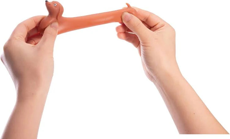 Hands stretching mini sausage dog toy to show its long flexible body — Adventure Awaits