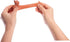 Hands stretching mini sausage dog toy to show its long flexible body — Adventure Awaits