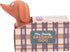 Mini stretchy sausage dog toy sitting in plaid kennel box — Adventure Awaits