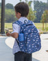 Child wearing a blue backpack with airplane pattern outdoors