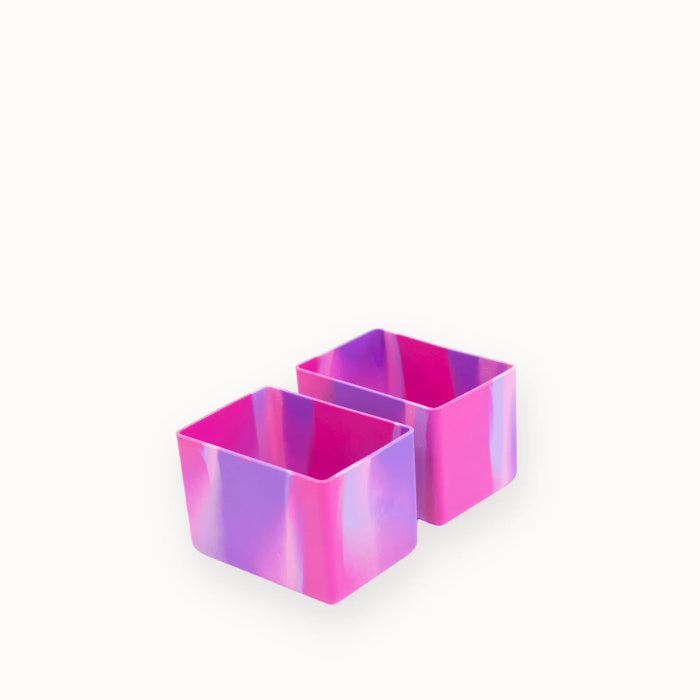 Two pink and purple marbled bento lunchbox divider cups on a plain background — Adventure Awaits