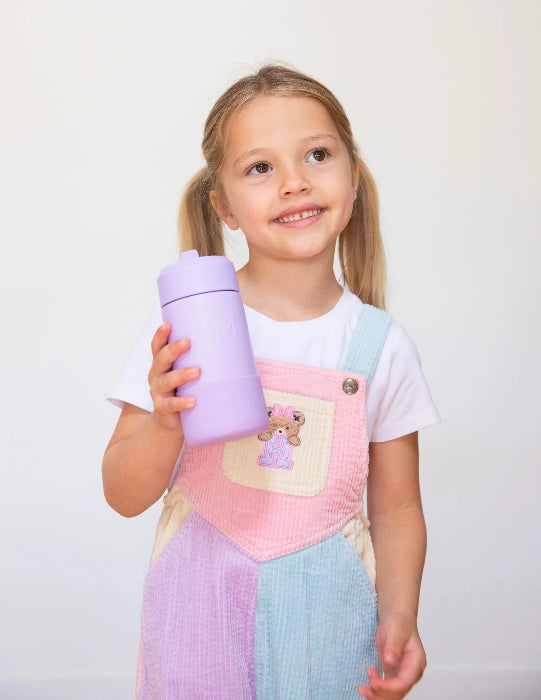 A little girl holding a lilac montiico fusion drink bottle